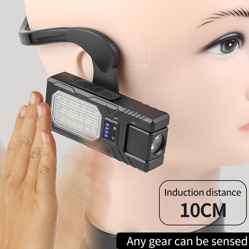 Hands-free magnetic base work light attached to a car hood for engine repair